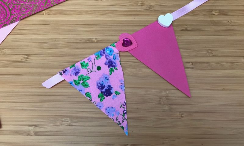 Apply the triangles to the ribbon to make the Valentines Day Bunting
