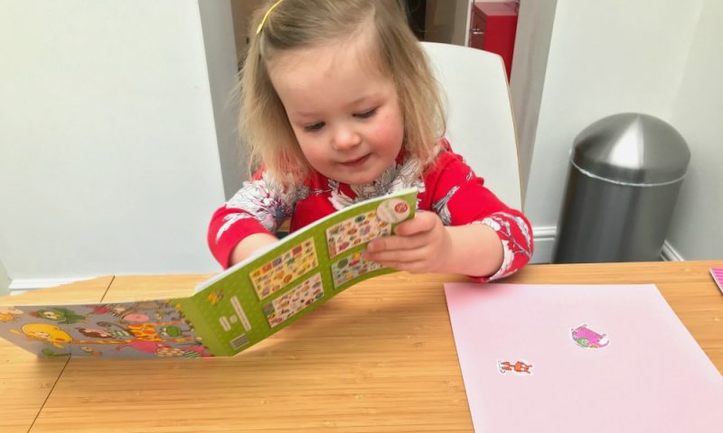 Toddler playing with the Jungle Stickers