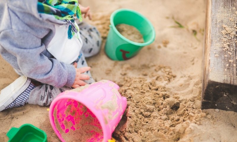 Child playing in a sand pit 
