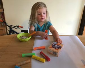 My daughter drawing and colouring, and reaching out for the Bassetts pack