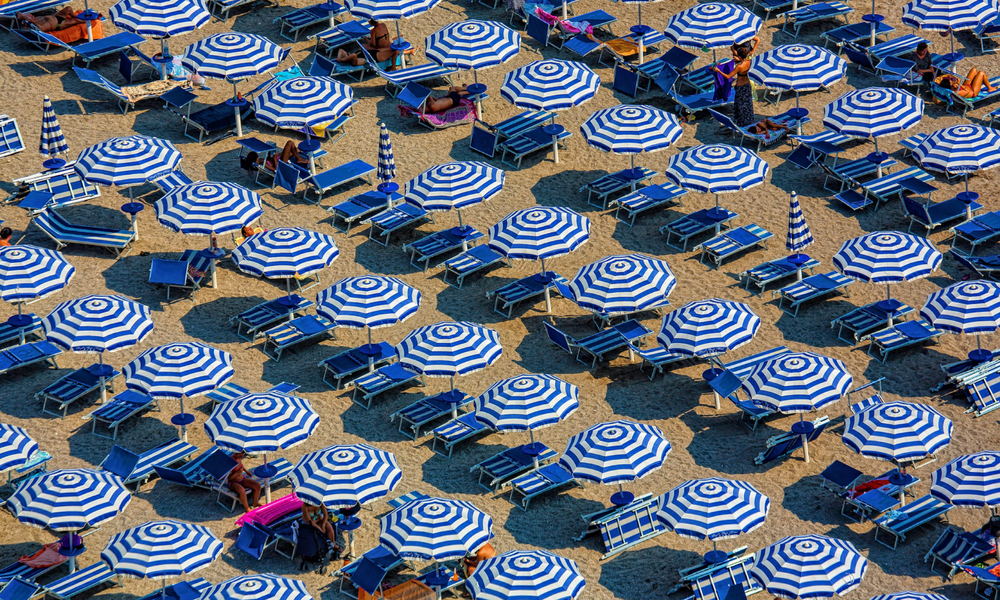 Umbrella on a beach in Spain where people are enjoying a family holiday