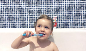 My daughter brushing her teeth with Aquafresh toothbrush and toothpaste