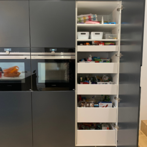 The larder cupboard open showing the 5 drawers and 2 shelves