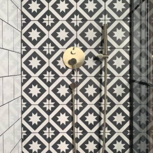 Mandarin stone Harlequin tiles with gold shower from Dowsing and Reynolds