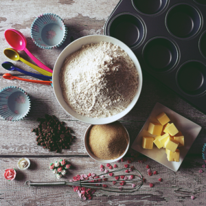 Spoons, bowls, knives, chopping boards as well as the ingredients to make the recipe are all things that you need for baking at home in the kitchen