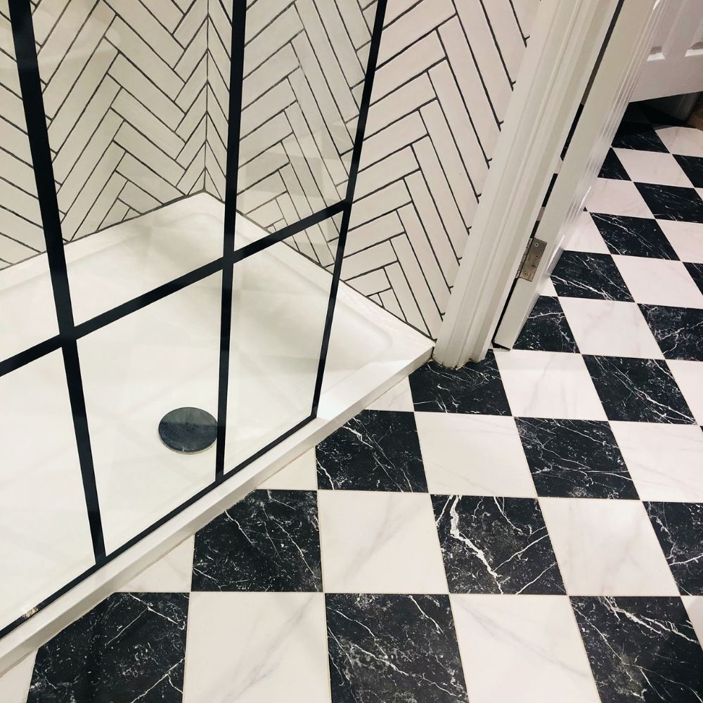 The finished monochrome bathroom with herringbone tiles