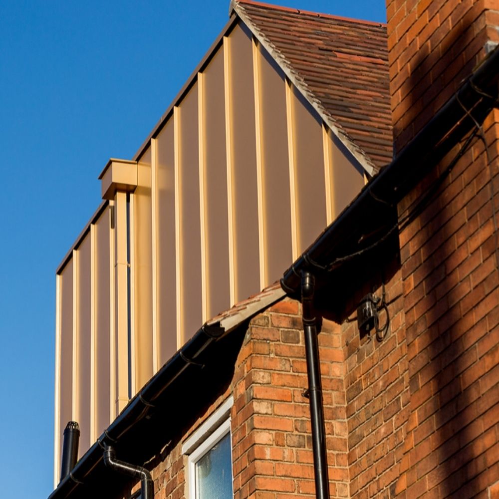The stunning and unusual gold cladding on the loft conversion. 