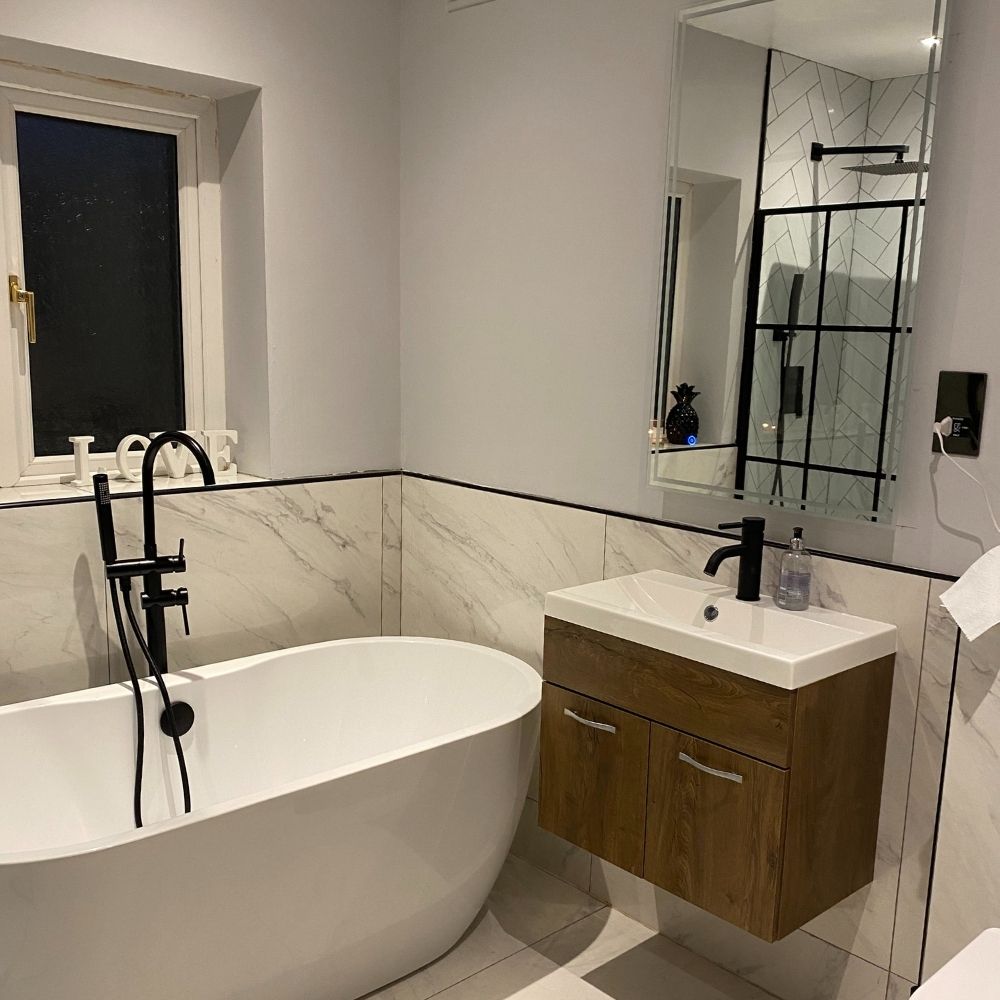 The newly renovated bathroom with a freestanding bath