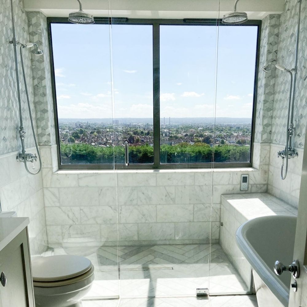 Another beautiful bathroom with a stunning view and double shower