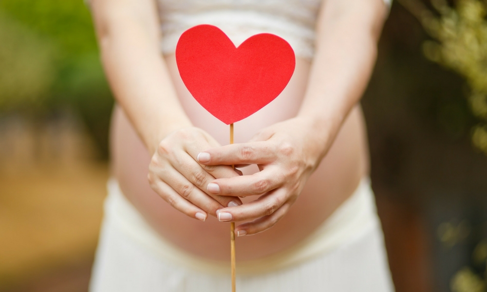 Pregnant lady holding a heart